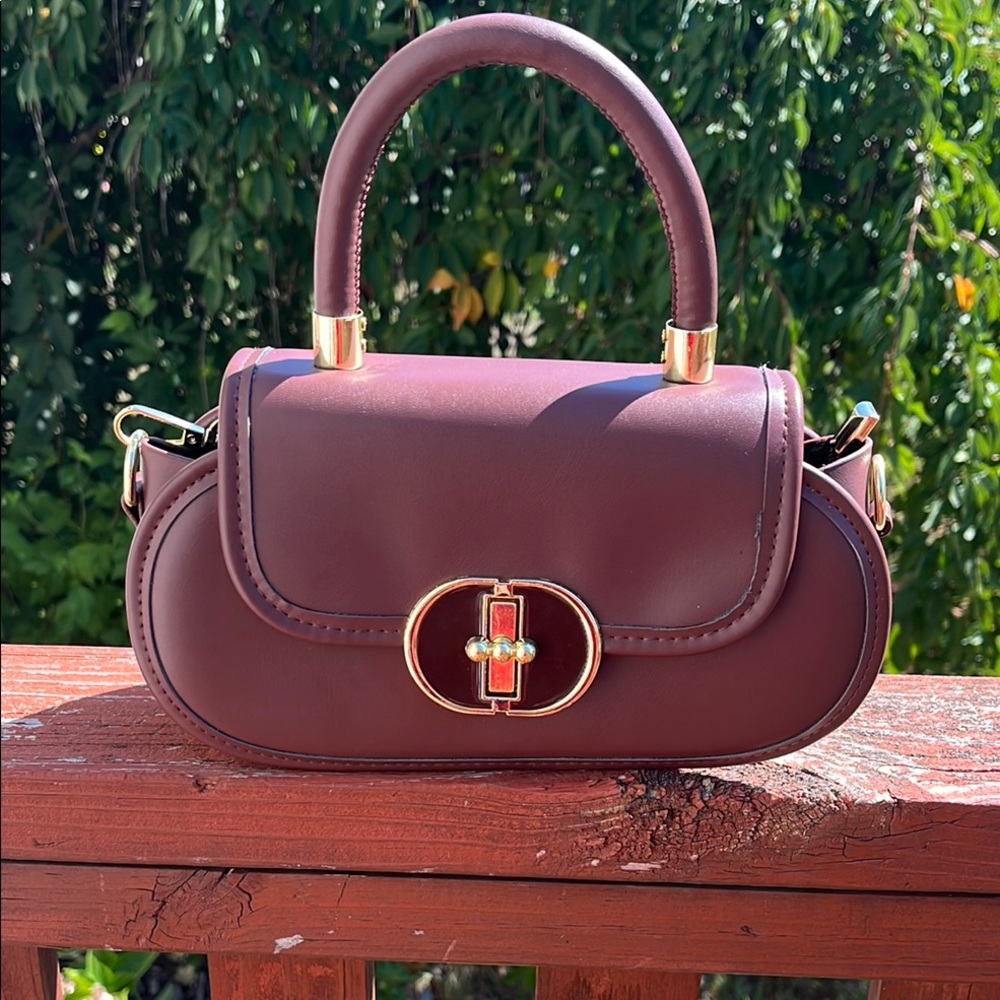 Burgundy Handbag with Gold Accents and crossbody strap. - Picture 1 of 3